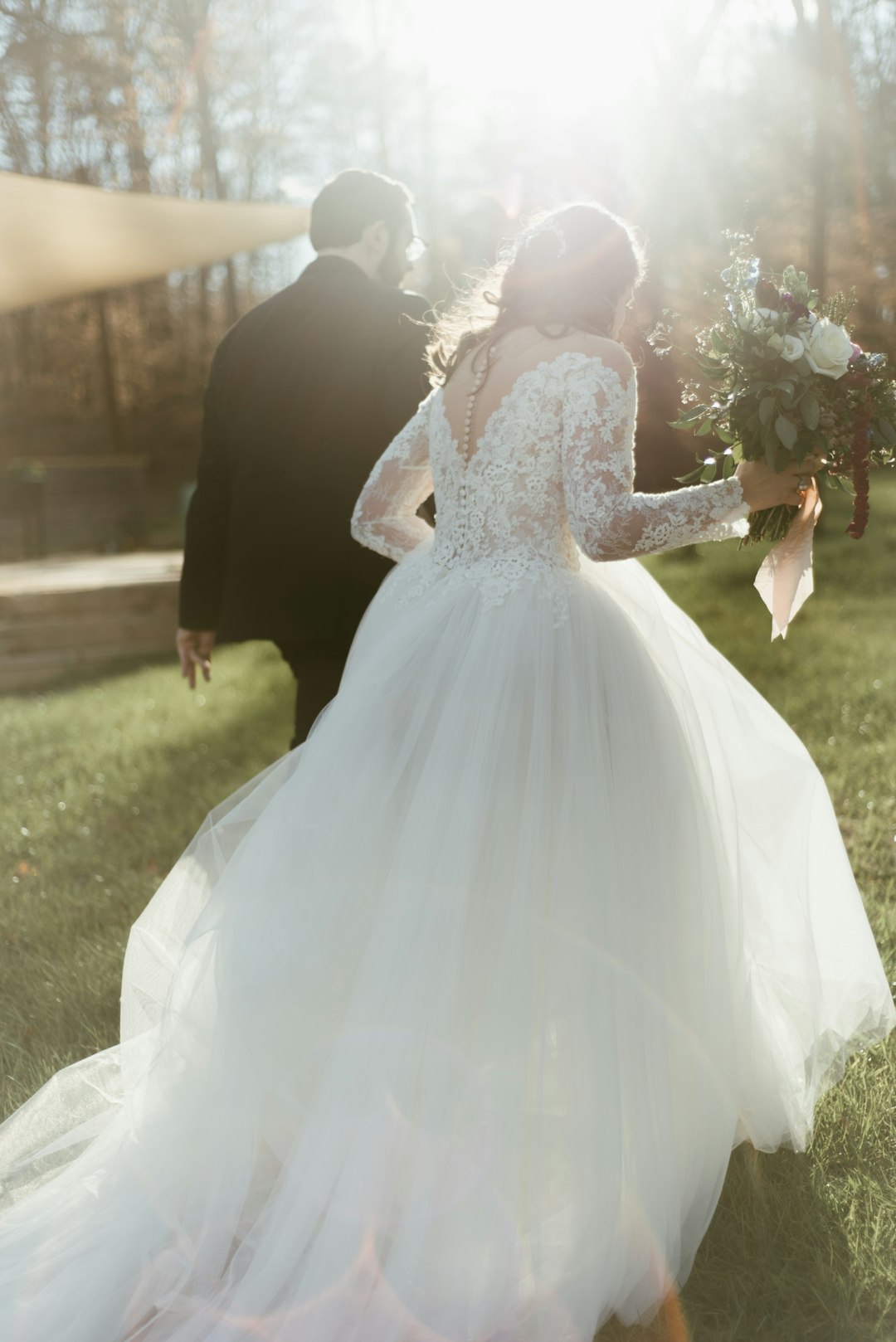 woman-in-white-wedding-dress-holding-bouquet-of-flowers-aul6nhvx7ci
